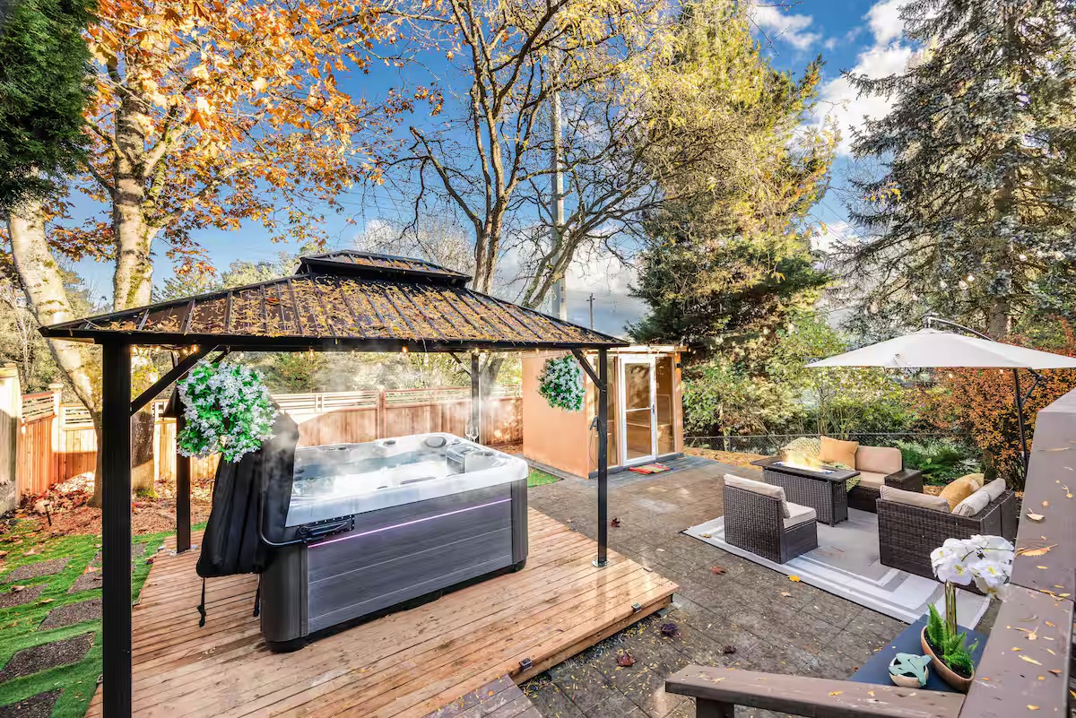 A private Seattle backyard with a hot tub and outdoor seating.